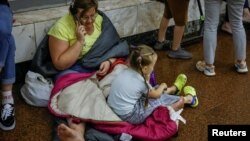 People shelter inside a subway station during an air-raid alert in Kyiv on July 26.
