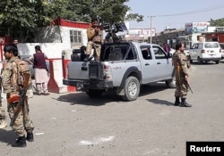 Afghan security forces stand guard at the entrance gate of the airport in Kabul on August 15.