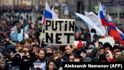 A protester holds a placard reading "Putin - No!" during an opposition rally in central Moscow in March 2019 to demand Internet freedom in Russia.