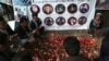 Afghans pray and light candles to pay tribute to Afghan journalists killed in a suicide attack in Kabul in April.