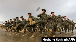 Afghan National Army soldiers march during a training exercise of a graduation ceremony at a training center in Herat Province.