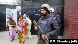 A Pakistani police commando stands guard outside a church during Christmas Mass in Lahore on December 25.