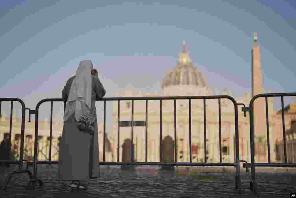 Vatican, 22 aprilie 2025 - o călugăriță privește spre Piața Sf. Petru.