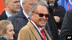 Американският режисьор Оливър Стоун на военния парад за Деня на победата в Москва, 9 май 2025 г. През 2017 г. Стоун излъчи документалната поредица "Интервюта с Путин", която беше определена като противоречива. 