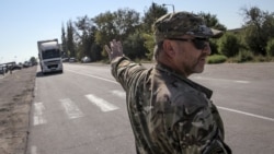An activist stops a lorry near the village of Chongar, in the Kherson region adjacent to Crimea.