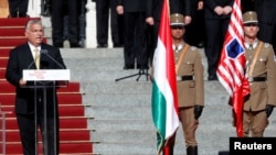 Hungarian Prime Minister Viktor Orban delivers a speech in front of the parliament building, before the unveiling ceremony of the 'Memorial of National Unity' commemorating the Trianon treaty, in Budapest, Hungary, August 20, 2020