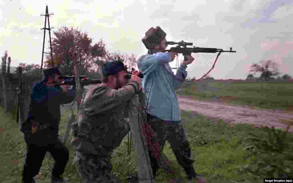 Chechen fighters watch federal troops through their rifle scopes on October 17.