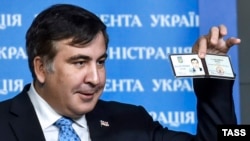 Former Georgian President Mikheil Saakashvili shows off his identification card as the head of an advisory council in Kyiv in February.