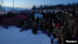 Ukrainian prisoners of war pose for a picture after a swap at an unknown location in Ukraine on February 16.