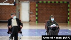 Një grua dhe një burrë pushojnë pasi kanë marrë dozën e tyre të parë të vaksinës AstraZeneca në një qendër vaksinimi në Prishtinë, 13 Prill 2021.