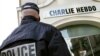 A policeman stands guard outside the French satirical weekly Charlie Hebdo office in Paris (file photo).