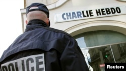 A policeman stands guard outside the French satirical weekly Charlie Hebdo office in Paris (file photo).
