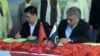 Chairman of Pakistan's Gwadar Port Authority Dostain Khan Jamaldini (R) and chairman of China Overseas Port Holding Company (COPHC), Zhan Baozhang (L) sign a document during a ceremony in the Gwadar in November.