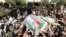 Iranians carry the coffin of General Nourali Shoushtari, one of the Revolutionary Guards commanders killed in the suicide attack claimed by Jundallah.