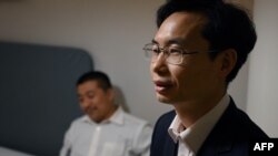 Zhang Zhan izgledala je shrvano kad je izrečena kazna, rekao je Ren Quanniu, jedan od njenih advokata (lijevo na fotografiji sa drugim braniocem, Zhang Kekeom - desno)