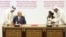 U.S. peace envoy Zalmay Khalilzad (left) and Mullah Abdul Ghani Baradar, the Taliban's top political leader, sign a peace agreement between Taliban and U.S. officials in Doha on February 29.