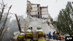 Rescuers clear debris at a Kyiv apartment building hit by Russian air attack on July 31, 2025
