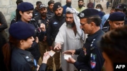 Pakistanski policajci proveravaju dokumente avganistanskih izbeglica tokom operacije potrage za ilegalnim imigrantima na periferiji Karačija, 17. novembar 2023.
