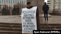 Гражданский активист Асхат Жексебаев у монумента Независимости на площади Республики проводит пикет в защиту политических заключенных. Алматы, 11 ноября 2019 года.