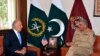 FILE: U.S. peace envoy Zalmay Khalilzad (L) talks with Pakistani Army Chief General Qamar Javed Bajwa in Rawalpindi, December 2018.