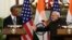 Indian Prime Minister Narendra Modi (R) reaches out to shake hands with U.S. President Barack Obama on January 25.