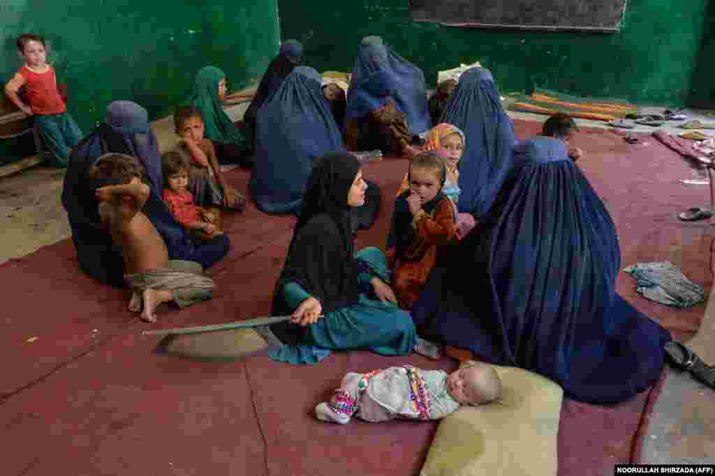 Displaced families sit inside a school in the Ghaziabad district of the northern part of Kunar Province on August 7. They fled their homes following fighting between Afghan security forces and Taliban militants. Over 9,000 families have been displaced in the province and are in desperate need of food and shelter.
