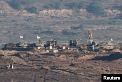 Soldați israelieni în acțiune în Gaza, la 7 iulie 2025, văzuți din Israel.