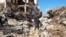 Members of Libyan Red Crescent Ajdabiya work in an area affected by flooding, in Derna