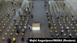 Iranians wait to receive a vaccine against COVID-19 at a vaccination center in Tehran on August 9.