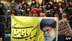An Iranian girl holds a banner bearing a portrait of supreme leader Ayatollah Ali Khamenei during a campaign meeting of the head of the conservatives grand coalition in February.