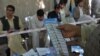 Afghan election workers count ballots. 
