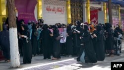 Afghan women stage a protest for their rights at a beauty salon in the Shahr-e Naw area of Kabul on July 19.