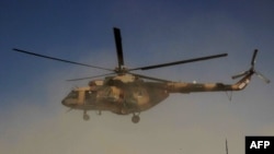 An Afghan helicopter during an offensive against Taliban insurgents in Kunduz in September 