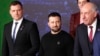 Ukrainian President Volodymyr Zelenskyy looks toward Hungarian President Tamas Sulyok during a group photo at a summit in Lithuania in April 2024.