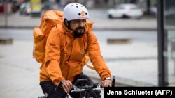 Sayed Sadaat, fost ministru al comunicațiilor din Afganistan, surprins într-o fotografie în Leipzig, estul Germaniei, 29 august 2021. Sadaat, ministru în Afganistan din 2016 până în 2018, spune că a renunțat pentru că se săturase de corupție. Acum este curier în Germania.