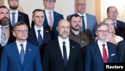 Ukrainian Prime Minister Denys Shmyhal (center) is flanked by Ukraine's Foreign Minister Dmytro Kuleba (left) and Czech Prime Minister Petr Fiala (right) in Prague on July 16.
