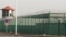 CHINA -- A guard tower and barbed wire fences surround an internment facility in the Kunshan Industrial Park which has previously been revealed by leaked documents to be a forced indoctrination camp in Artux in western China's Xinjiang region, December 3,