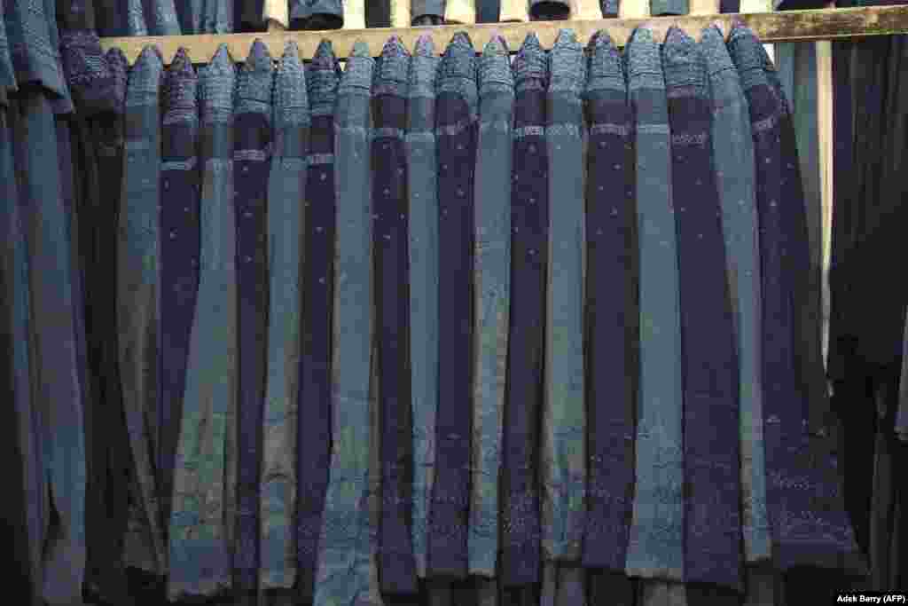 Burqas for sale at a shop in Kabul on June 30. These are some of the dozens of recent photos from news agencies capturing a widespread return of the burqa as the Taliban tightens its grip on Afghanistan. &nbsp;