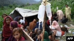 Afghan women and girls wait for treatment at a field clinic following earthquakes in Kunar Province, eastern Afghanistan, on September 1.
