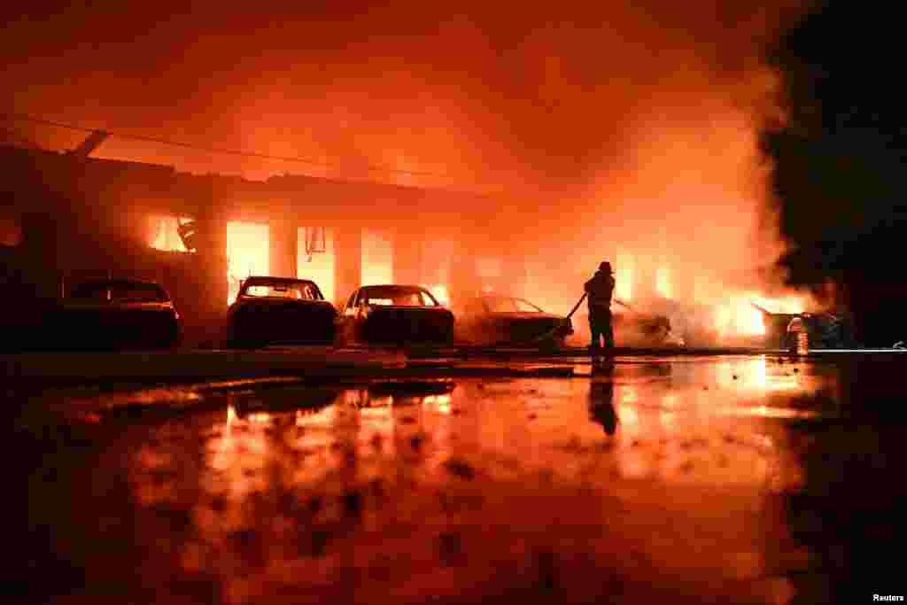 Пожарный работает на месте частного предприятия, пострадавшего от удара российского беспилотника, во время нападения России на Украину, в Запорожье, Украина, 18 июня 2025 года. REUTERS/Stringer