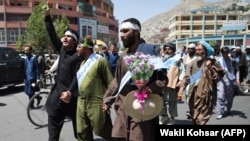 Afghan peace activists shout slogans to demand an end to the war as they arrived in Kabul on June 18.