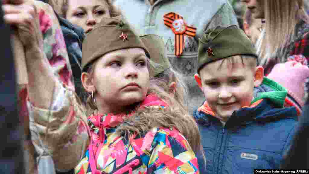 Children wait to place flowers by the eternal flame in a park named after cosmonaut Yury Gagarin in Simferopol, Crimea.
