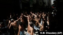 Pakistani Shi'ite Muslims gather to commemorate the death anniversary of Imam Ali, the son-in-law and cousin of Prophet Muhammad and the first Imam of Shi'ite Muslims, in Lahore on May 15.