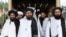 FILE: Taliban deputy leader Mullah Abdul Ghani Baradar (C) with members of the Taliban political office in Qatar.