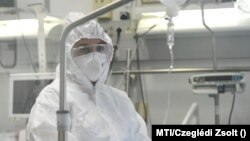 Egészségügyi dolgozó egy, a Richter Gedeon Nyrt. gyógyszergyár által kifejlesztett, remdesivir hatóanyagot tartalmazó koronavírus elleni szerrel kezelt beteg mellett a Debreceni Egyetem Kenézy Gyula Egyetemi Kórház Infektológiai Intézetében 2020. október 15-én. 